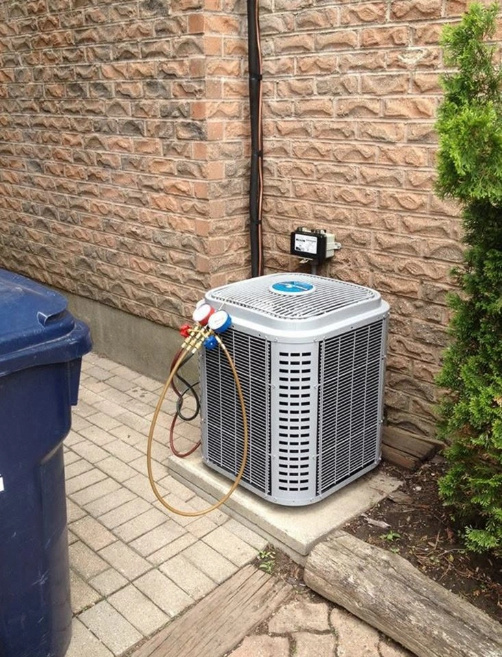 HVAC technician performing routine maintenance on a unit in Atlanta, GA